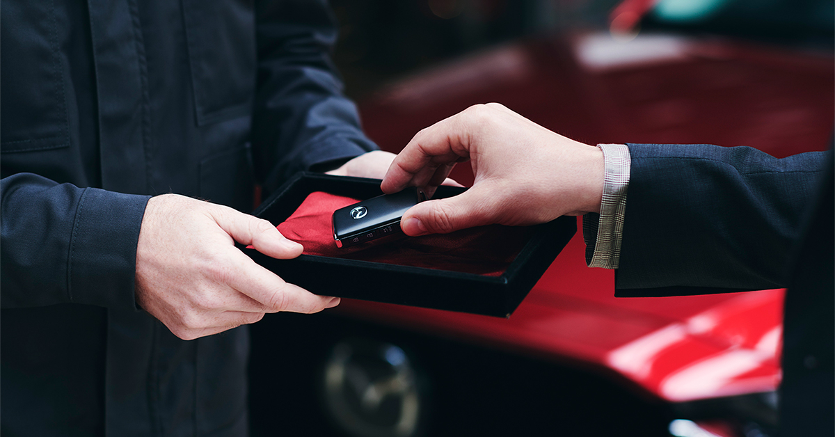 Hand taking a Mazda key from a box