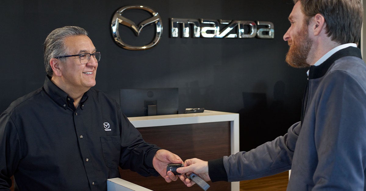 Mazda customer at couter learning about Mazda warranties.